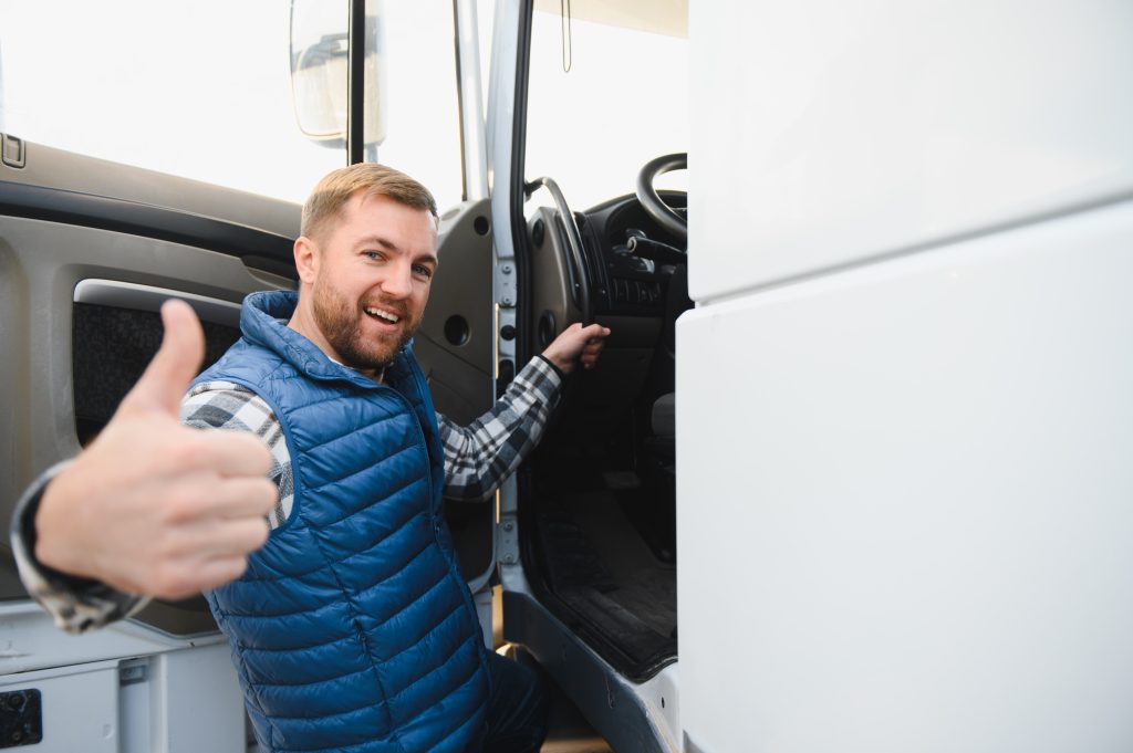 Truck driver prepares to climb into the cab of his truck.